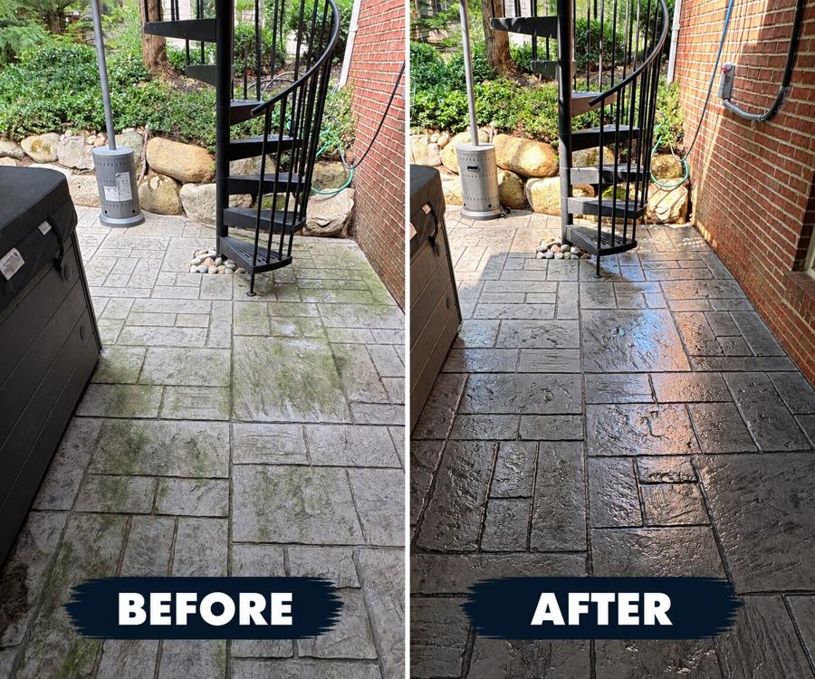 Stamped concrete patio before and after a seal coat: washed-out grey pavers with green algae in the joints on the left, deep evenly sealed stone on the right